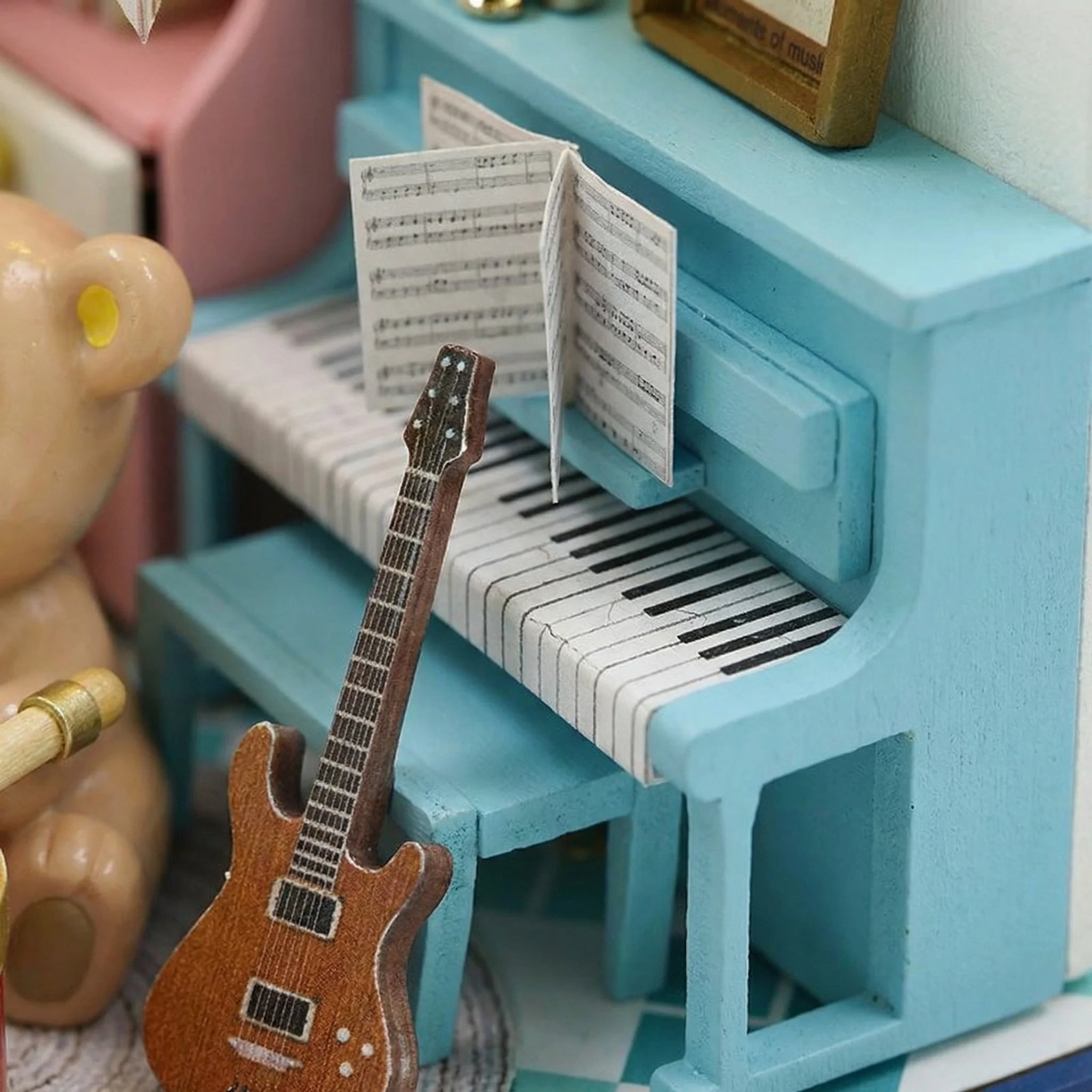 The Little Maestro miniature piano with guitar and sheet music showing detailed craftsmanship of DIY dollhouse kit