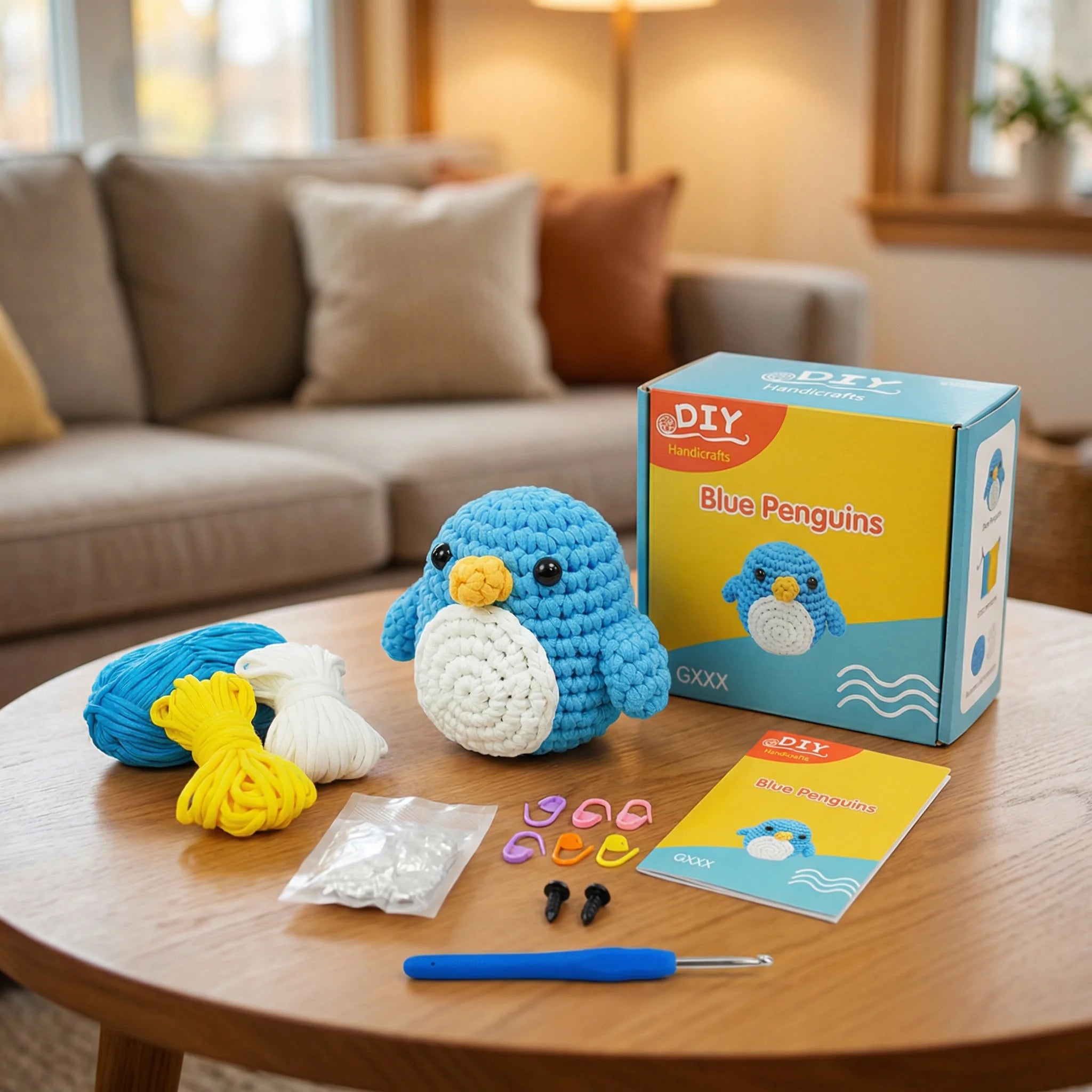 The Little Penguin DIY crochet kit contents with blue yarn, hook, stuffing, eyes and instruction booklet on table