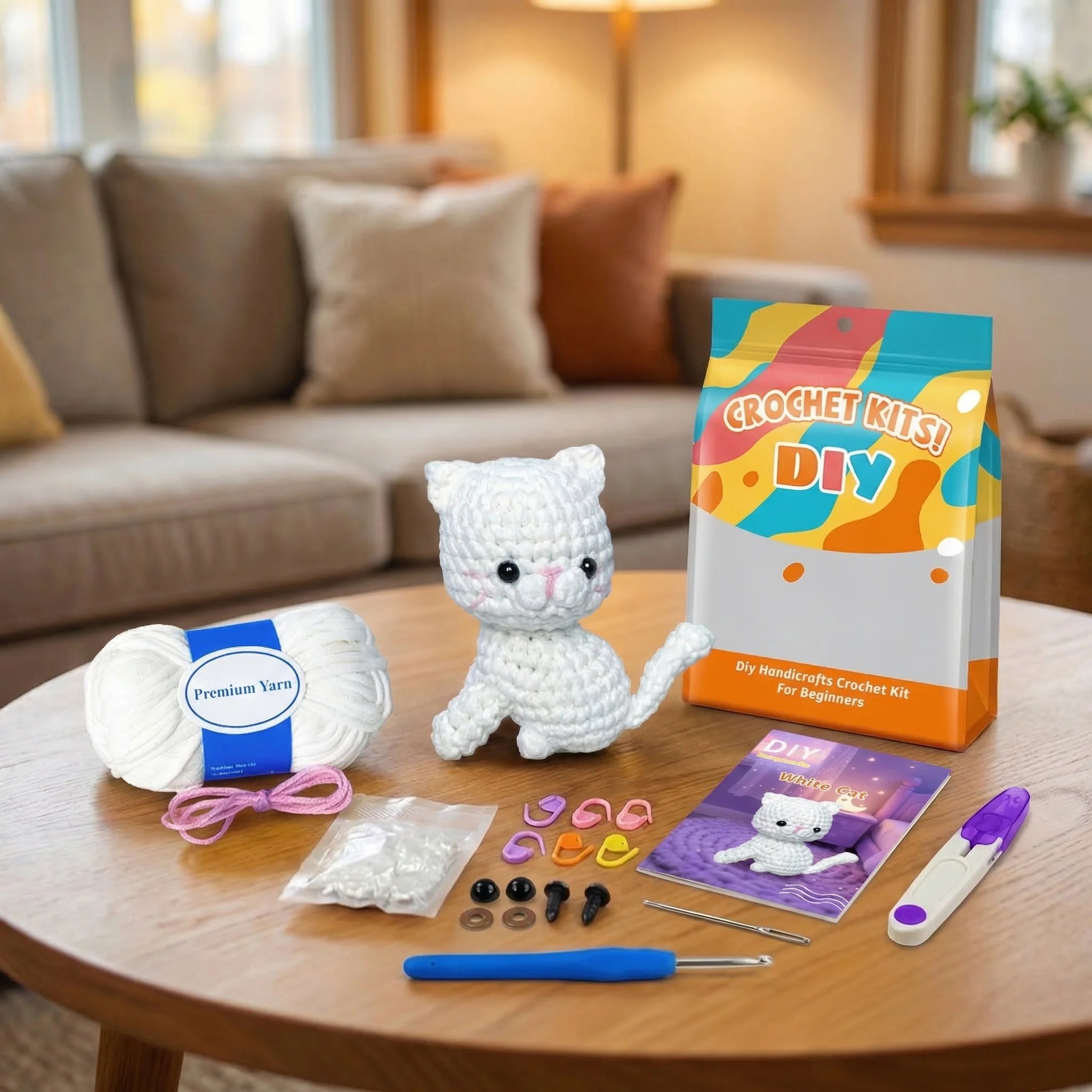 Snowball the Kitten DIY crochet kit contents including white yarn, hook, instruction booklet, and finished amigurumi cat