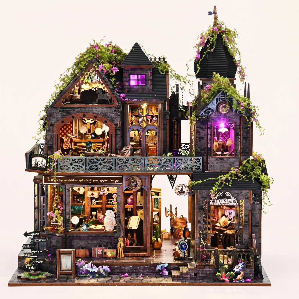 The Witch's Lair DIY miniature gothic mansion kit glowing amber and violet on a blush background