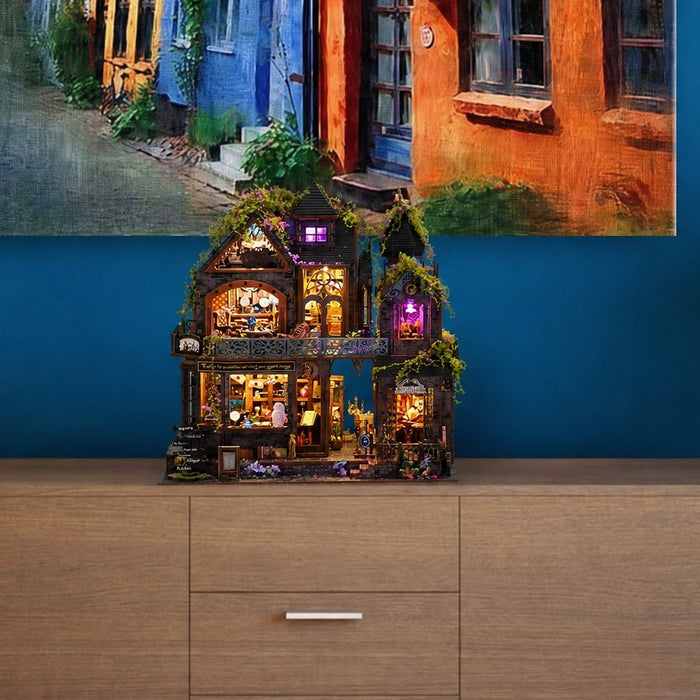 The Witch's Lair miniature kit lit up on a sideboard in a living room