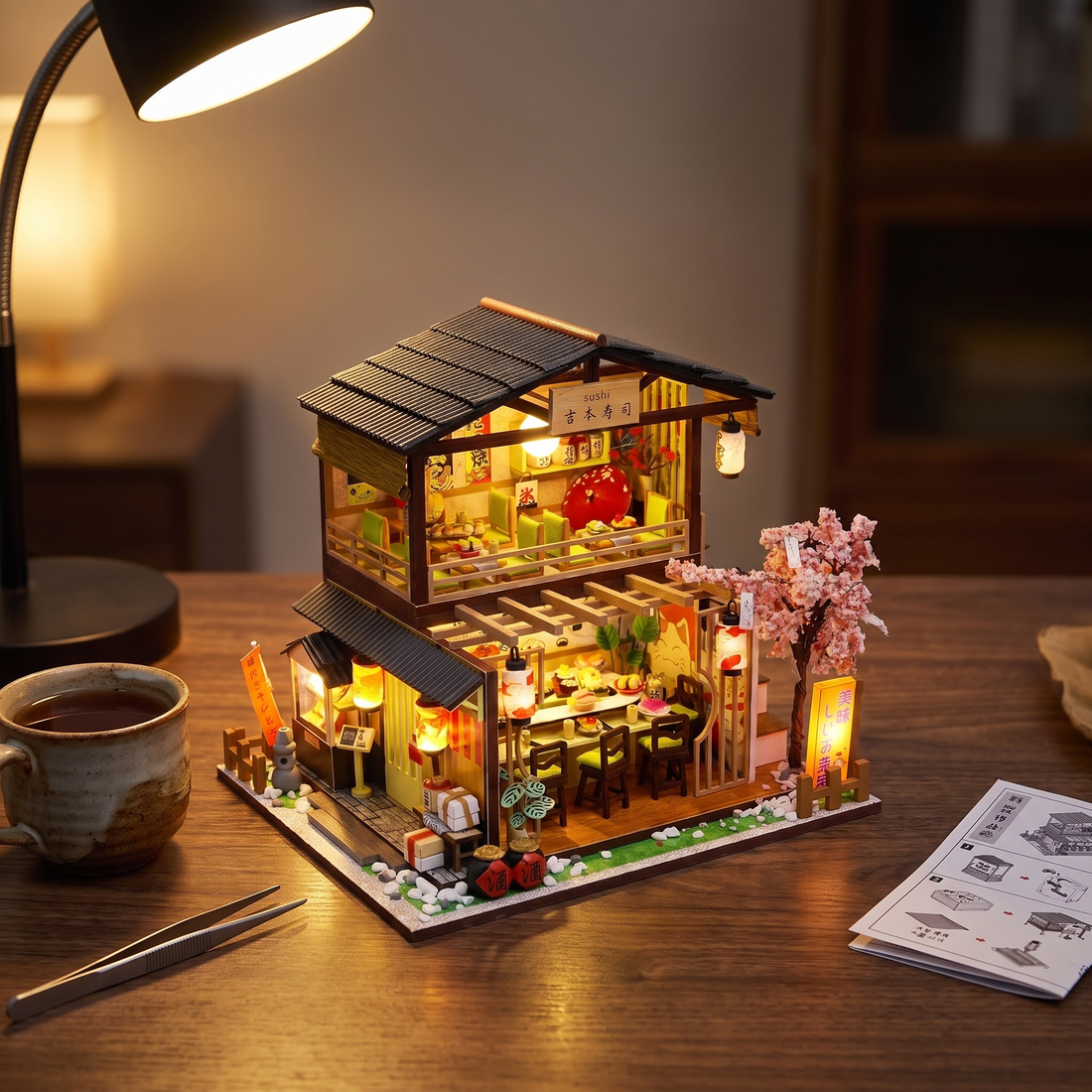 The Sakura Sushi Bar miniature kit lit on a desk in the evening
