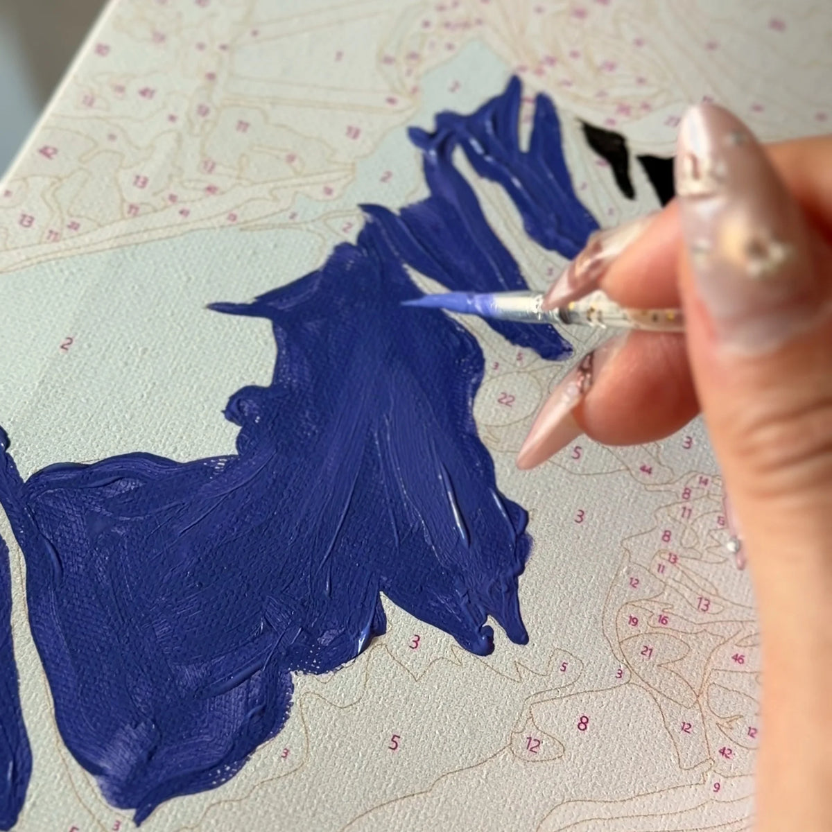 Painting a numbered section of the custom canvas