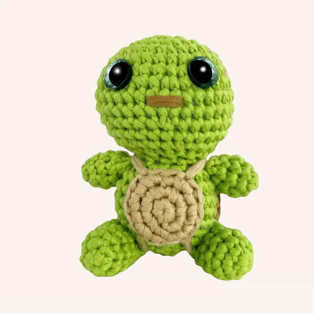 The Shell Keeper crochet turtle amigurumi with lime green body and tan shell featuring safety eyes