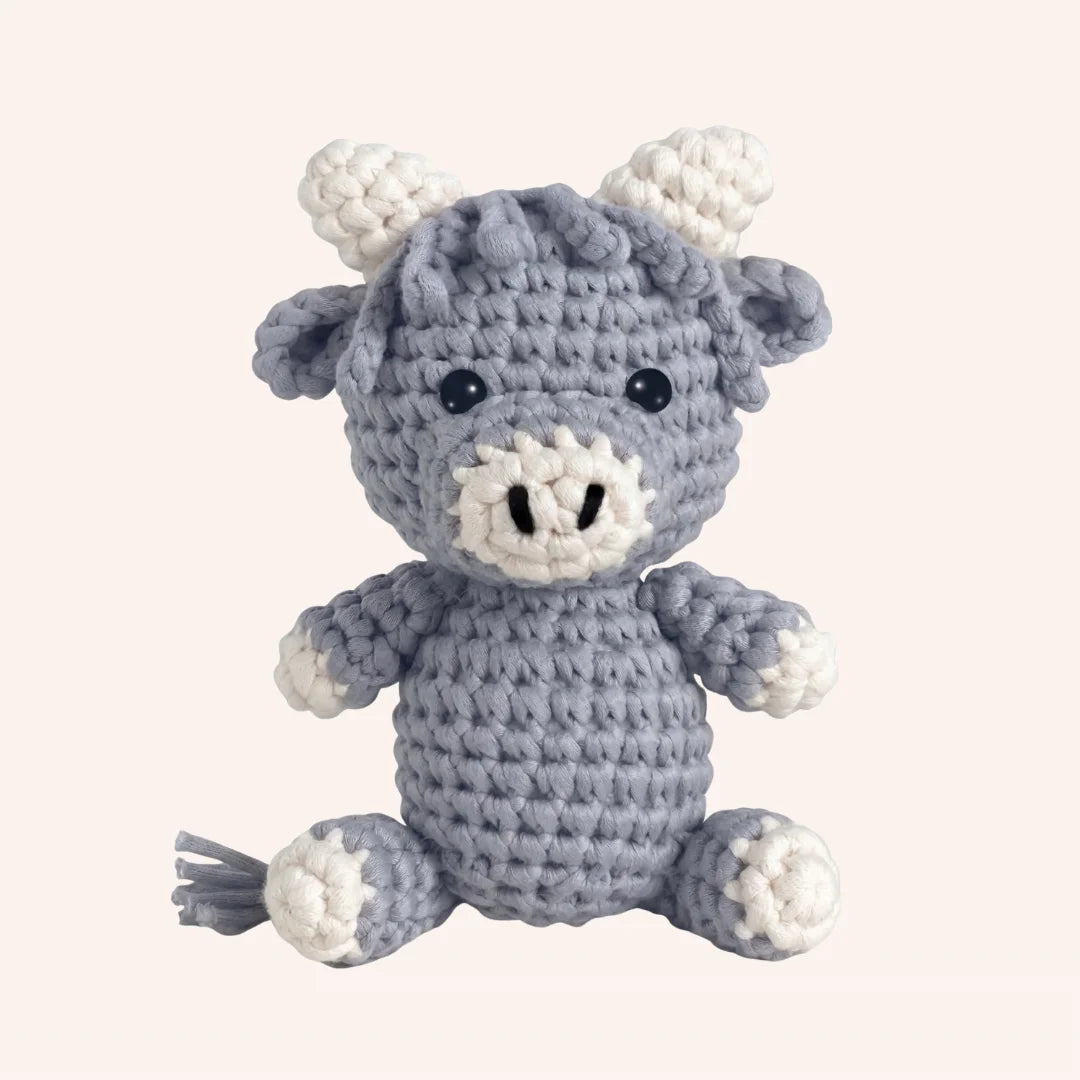 Bluebell the Cow mini crochet amigurumi kit with gray and white yarn featuring horns, ears, and tail