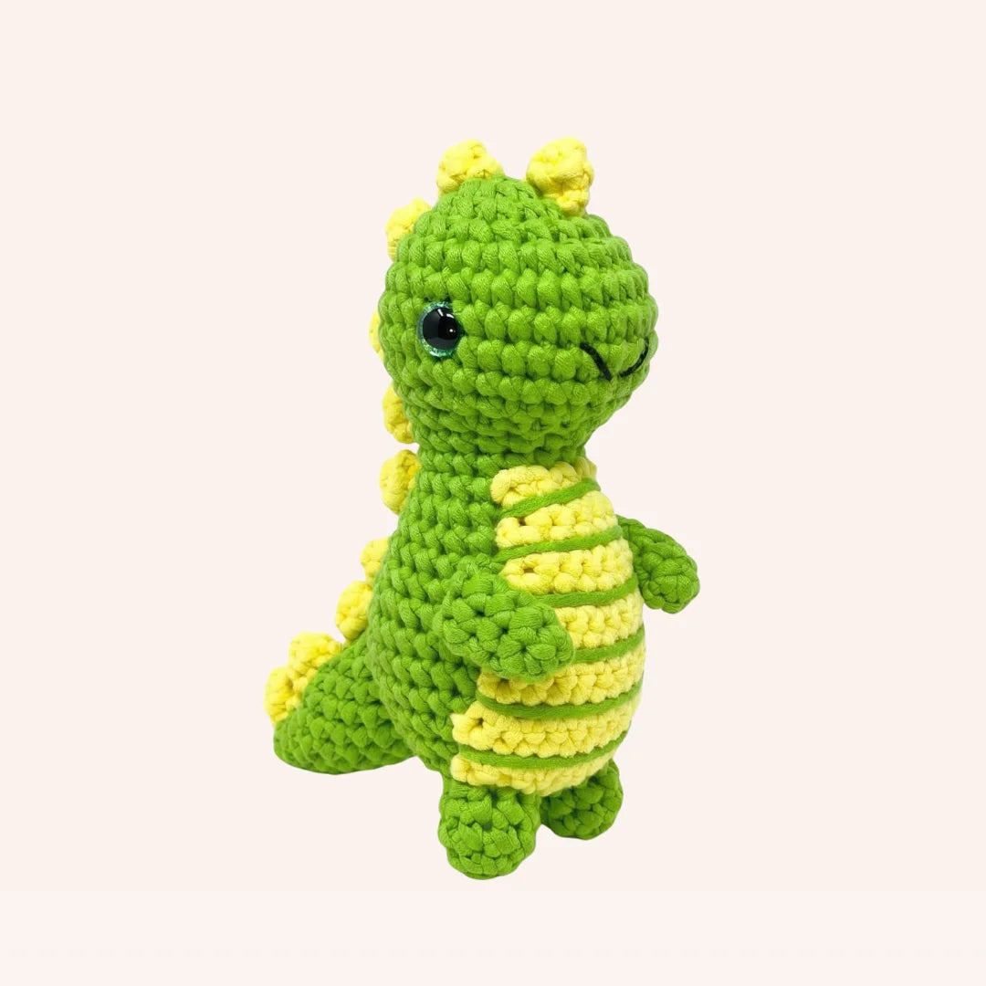 Rex the Dinosaur mini crochet amigurumi kit with green and yellow yarn in cute standing pose