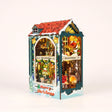 The Tartan Hearth DIY Christmas book nook kit, assembled with LED lights on