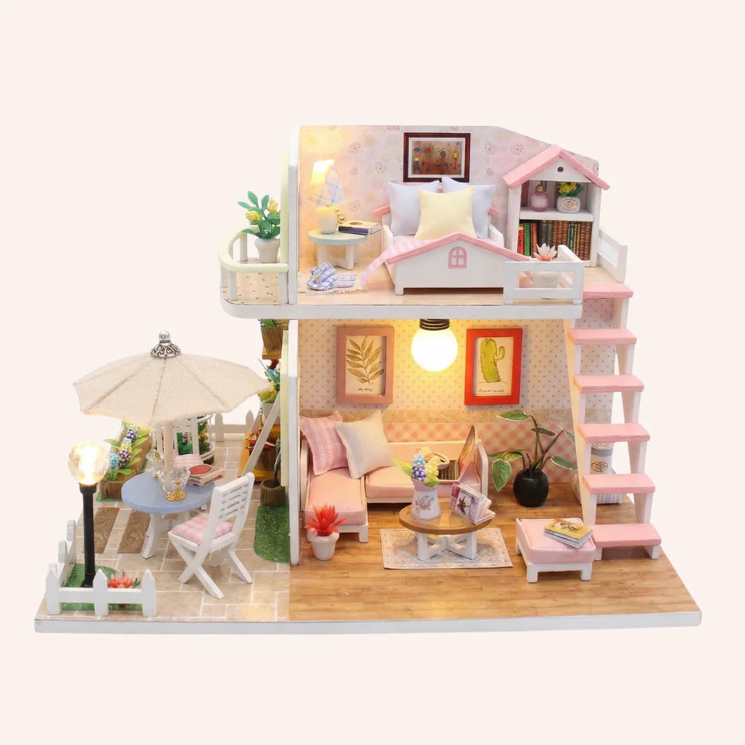 The Sunshine Loft DIY miniature dollhouse kit with pink roof, two-story interior, outdoor patio and working LED lights
