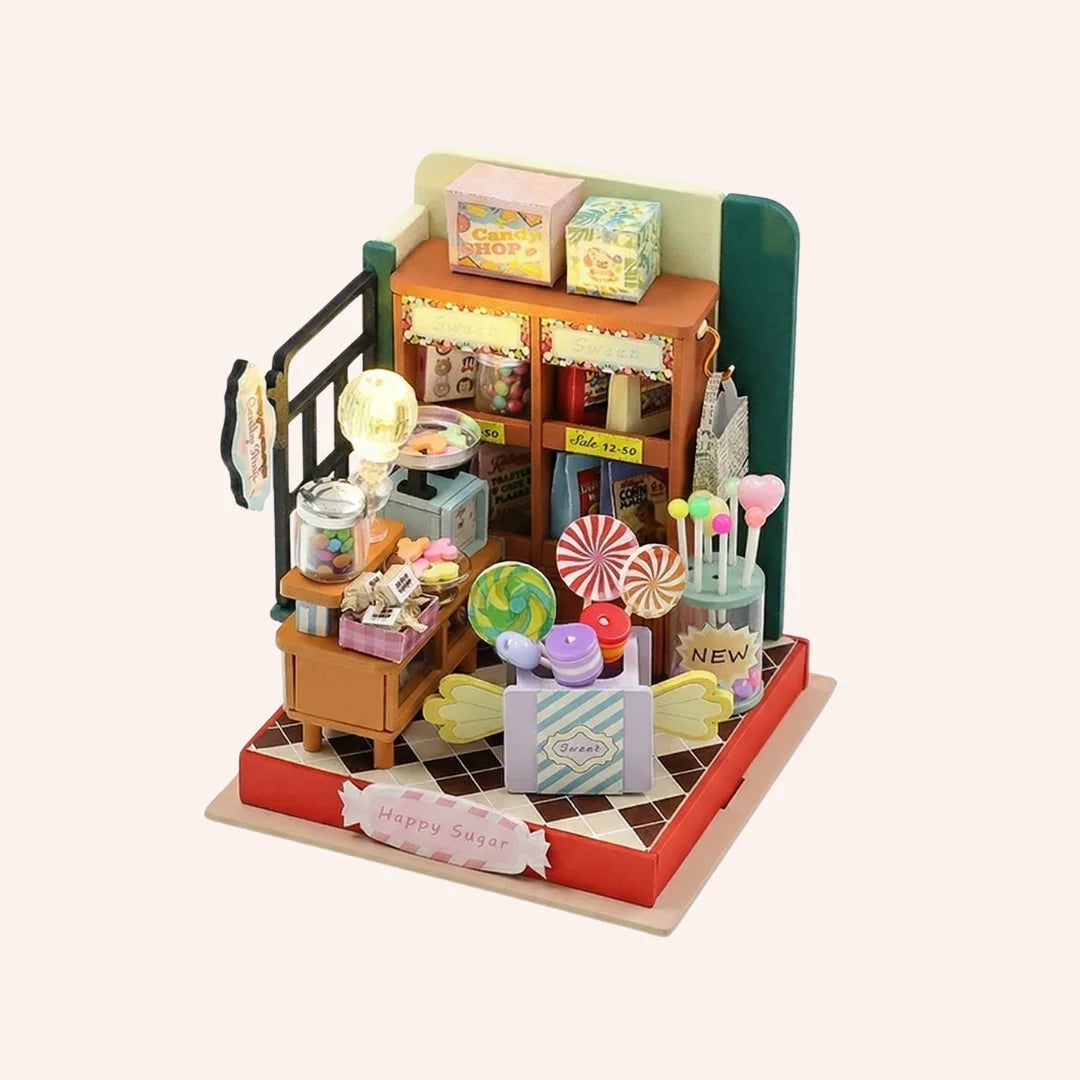 The Candy Counter DIY miniature kit with colorful lollipops gumball machine shelves and candy shop display