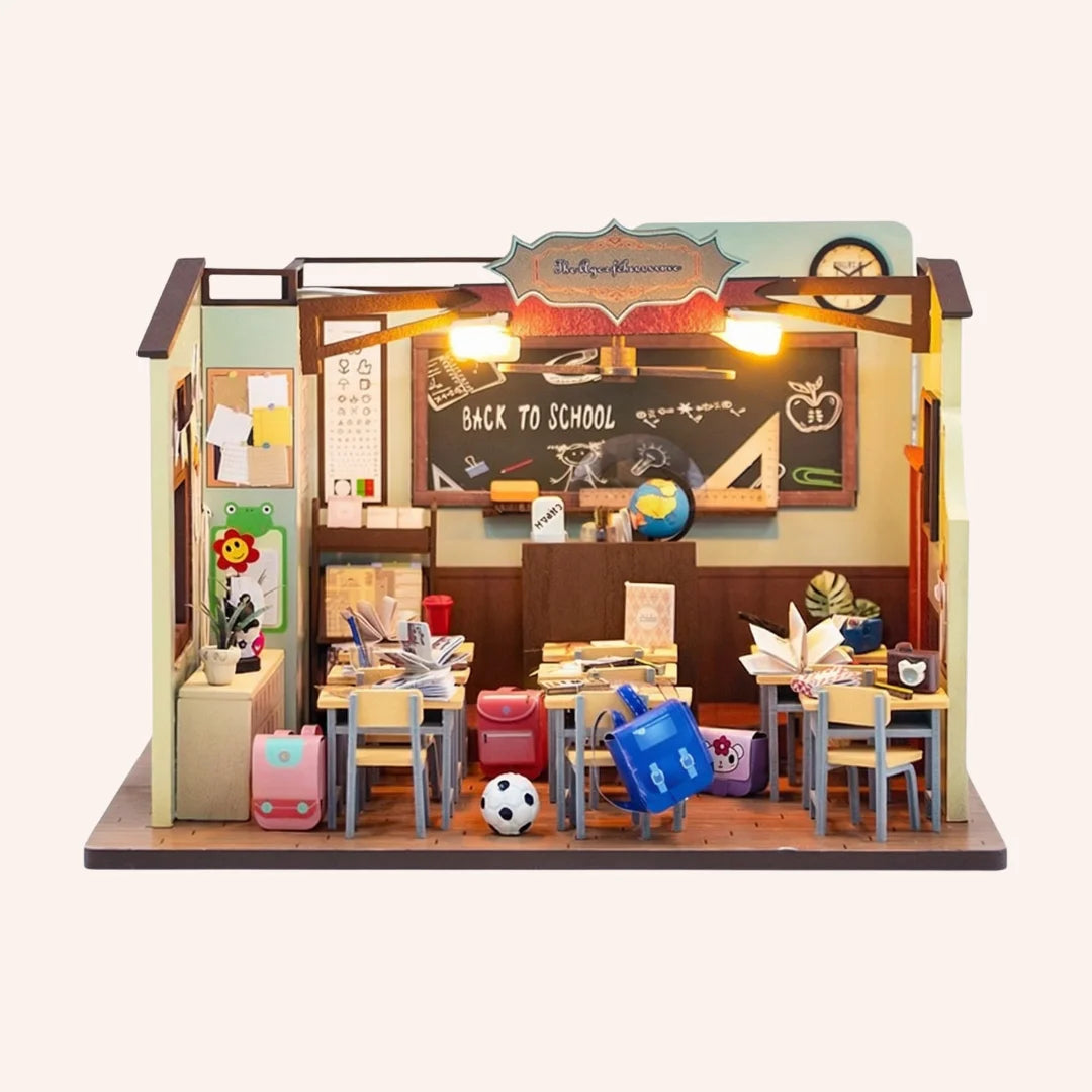 The Homeroom miniature classroom DIY kit with tiny desks, chalkboard, globe, and LED lights on wooden base