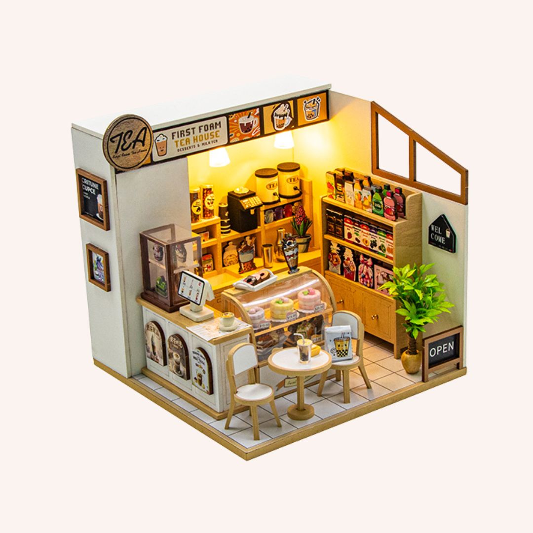 The Tea House miniature DIY kit with illuminated bubble tea shop interior featuring tiny furniture and detailed decor