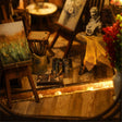 Close-up of the paint pots and brushes on the studio floor of The Artist's Studio