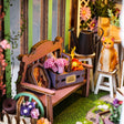 Flower bench detail: bouquet crate, watering can and tabby cat