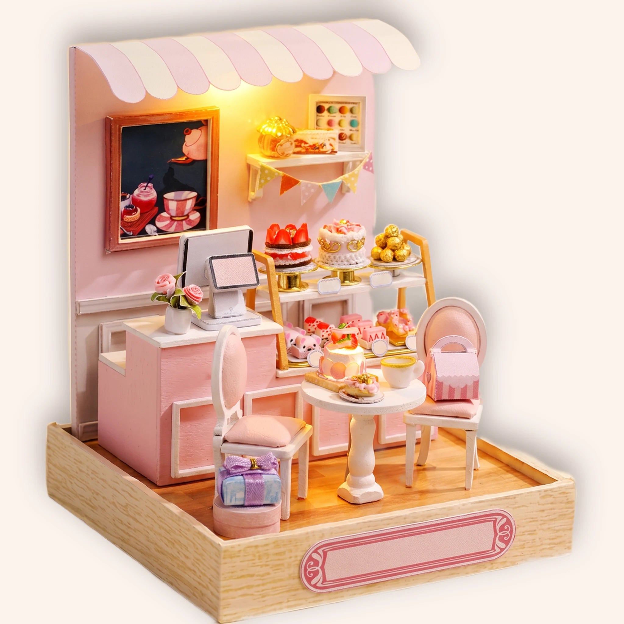 The Cake Shop miniature pastel pink dessert and tea shop roombox on a cream background