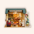The Christmas Parlour miniature roombox kit on a cream studio background