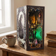 The Clockwork Apothecary book nook on a desk beside a mug of tea in soft window light