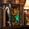 The Clockwork Apothecary book nook glowing green and amber between books on a walnut shelf