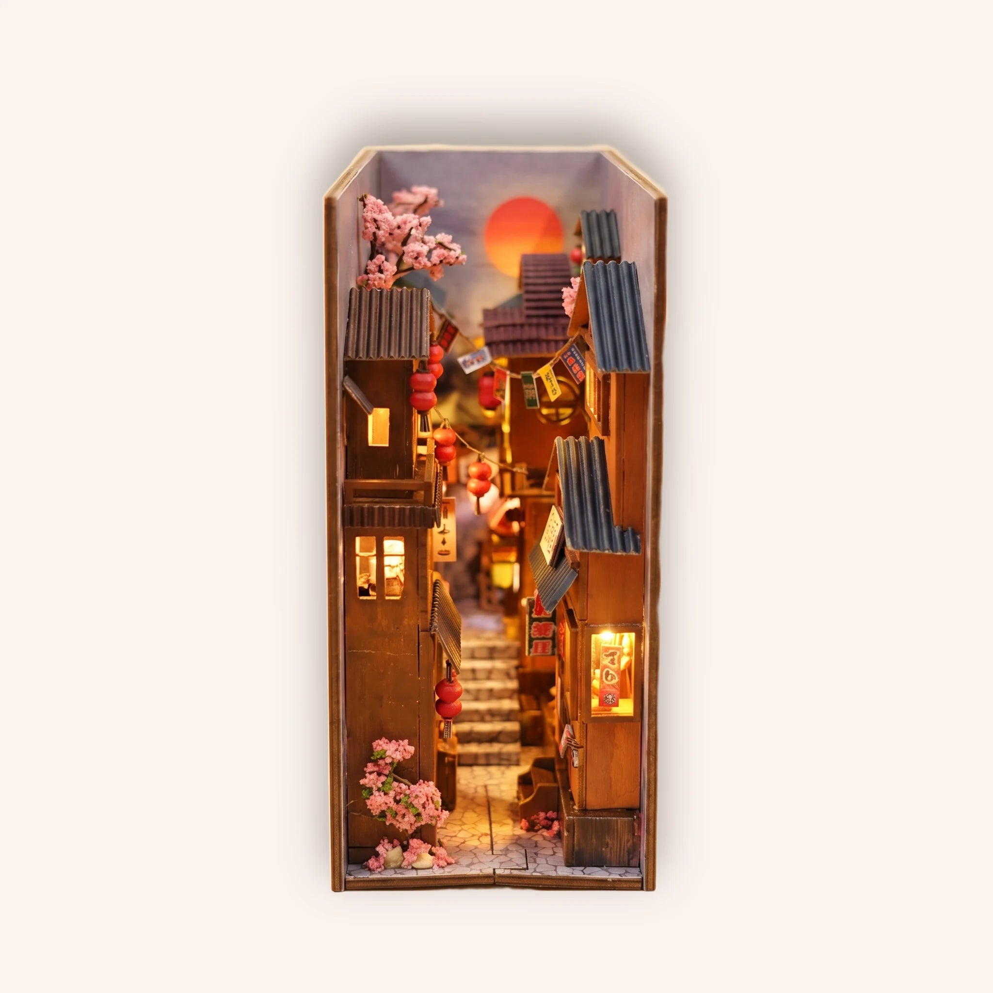 The Lantern Alley DIY book nook on a soft cream background, a Japanese old-town alley at dusk with red lanterns and cherry blossoms