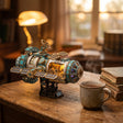 The Orbital Outpost on a desk at dusk beside a mug of tea