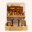 The Espresso Bar miniature DIY kit, a compact coffee bar with espresso machine and stools, on a cream background