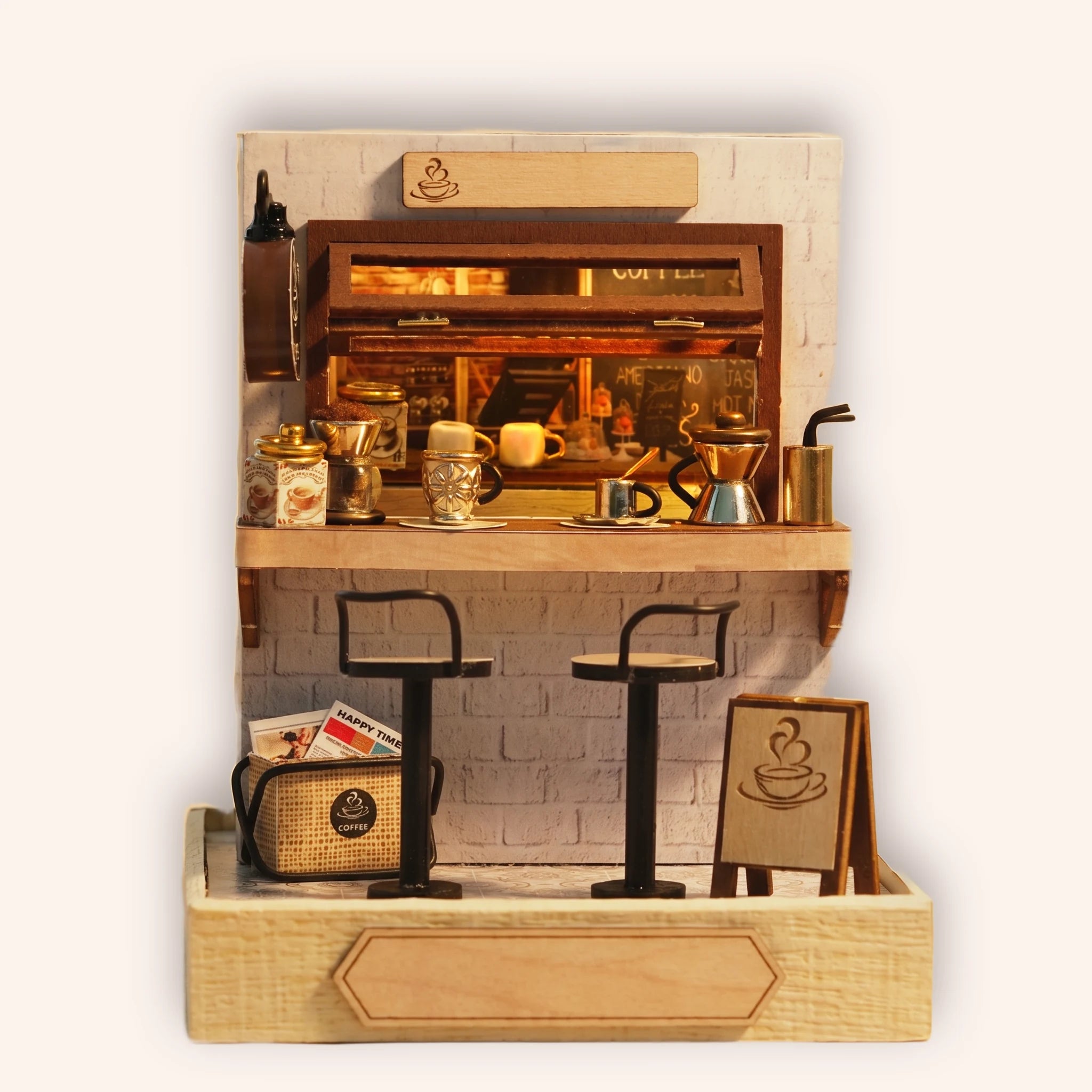 The Espresso Bar miniature DIY kit, a compact coffee bar with espresso machine and stools, on a cream background