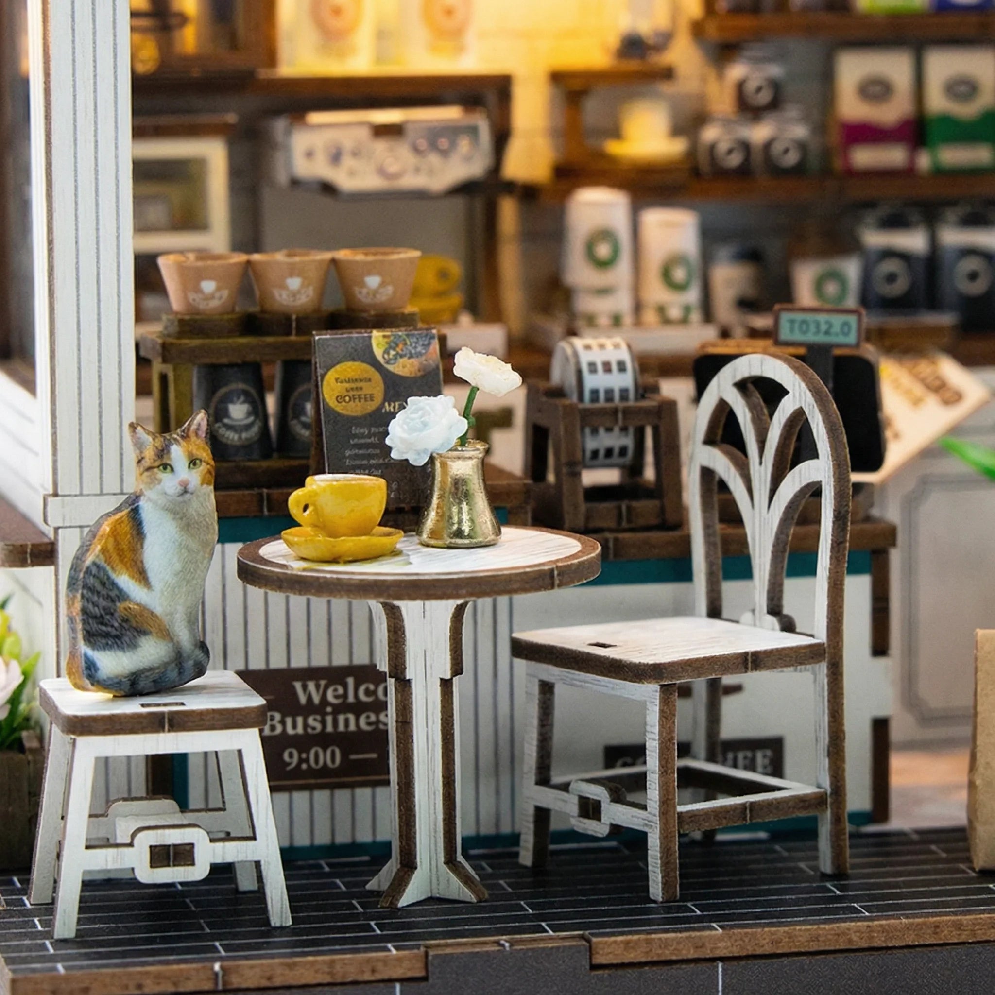 The Coffee Stop DIY miniature kit outdoor seating area with calico cat figure yellow cup and white flowers