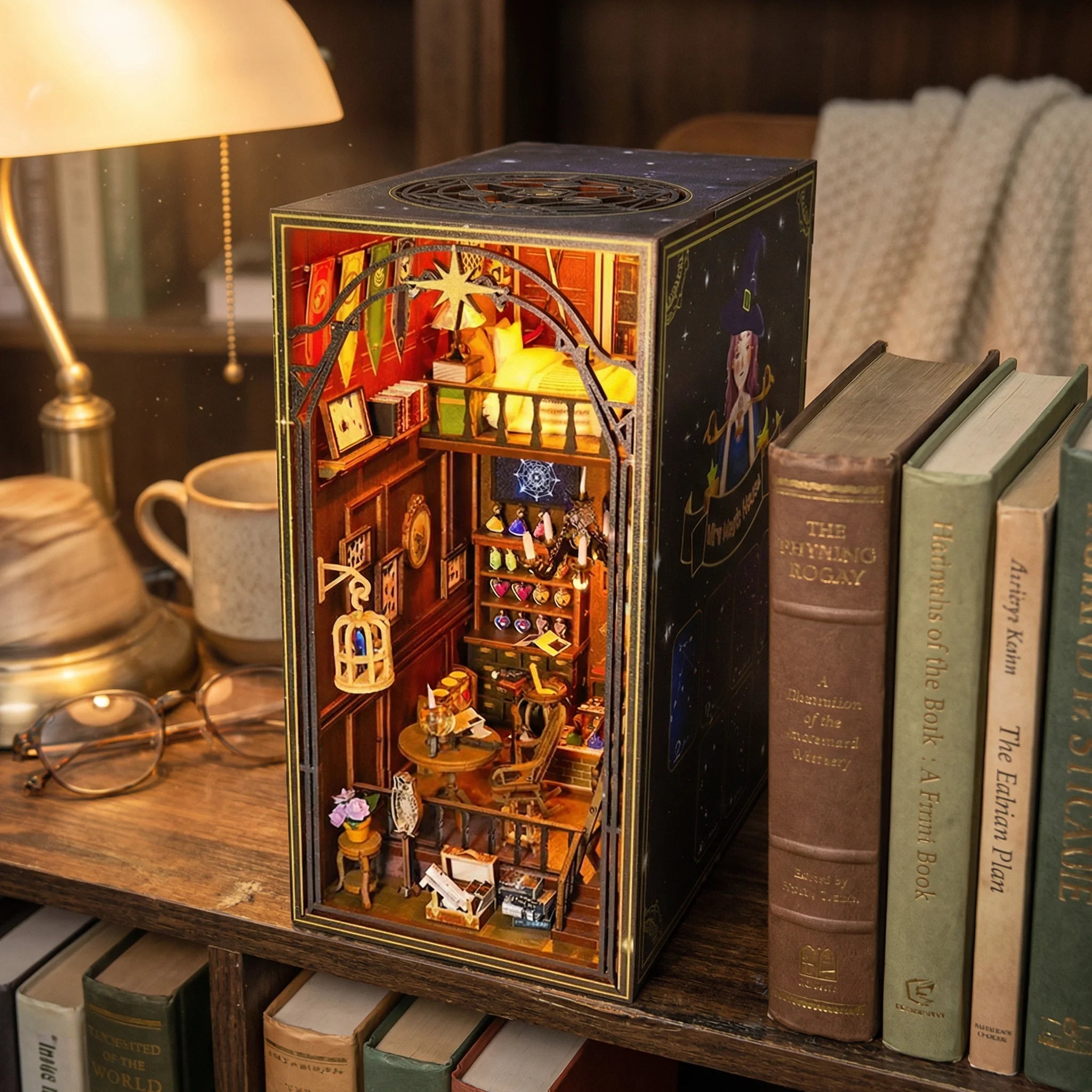 The Wizard's Study miniature book nook kit displayed on bookshelf with warm lighting and vintage books
