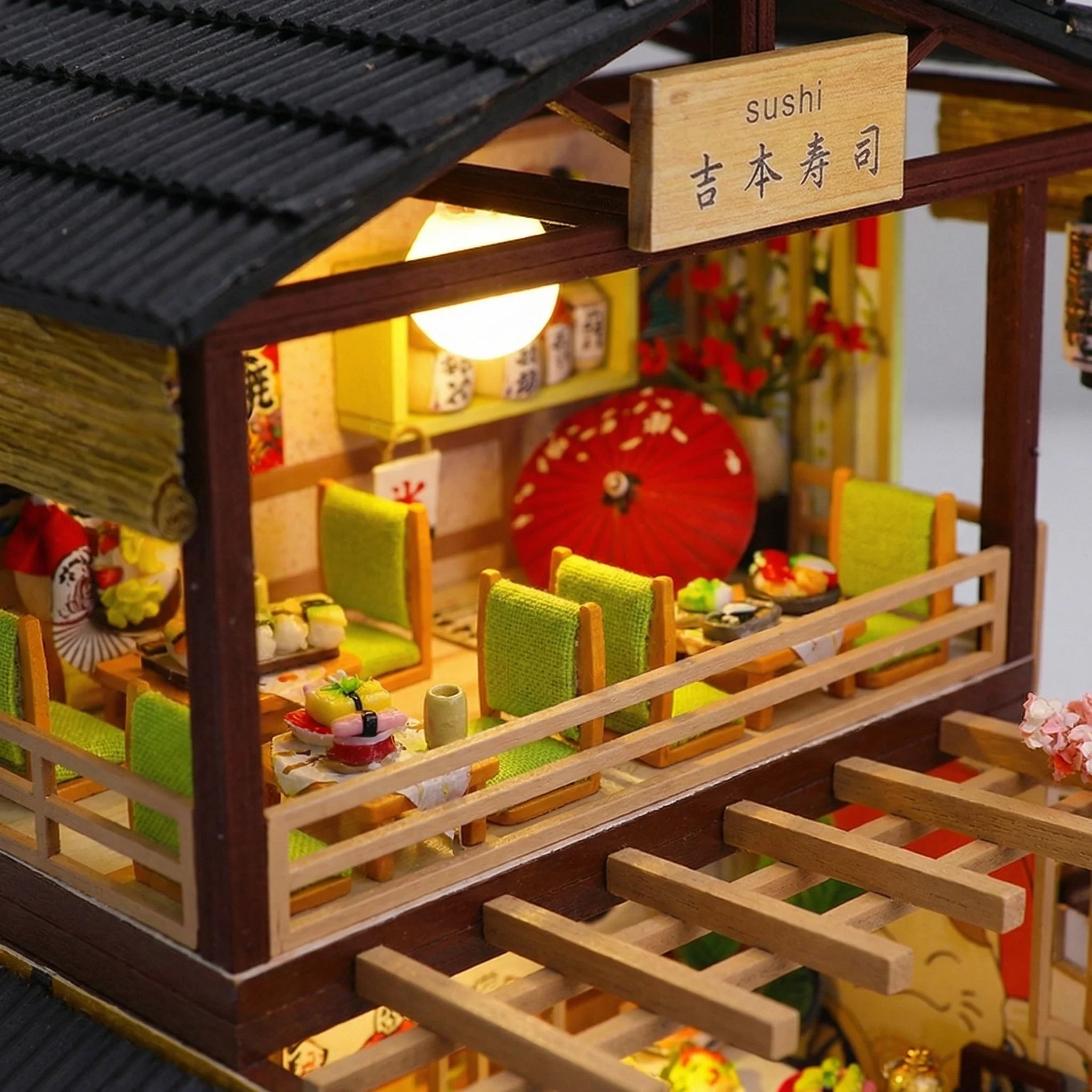 The Sakura Sushi Bar miniature kit interior with lime green booth seating, sushi plates, and red parasol decor