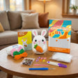 The Carrot Keeper crochet kit contents – yarn, hook, safety eyes and guide