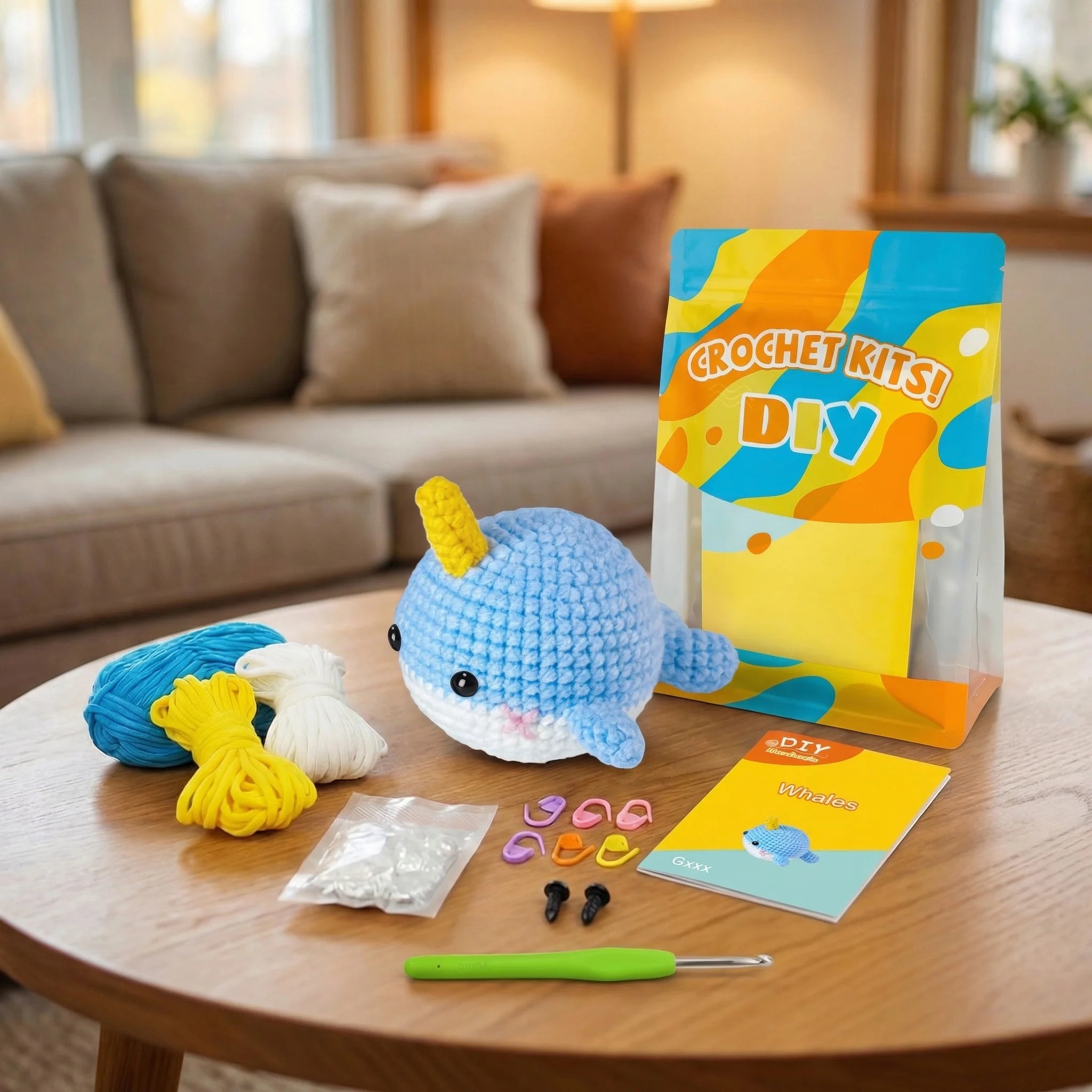 The Little Narwhal DIY crochet kit contents including yarn, hook, stuffing, eyes, and instruction booklet on table