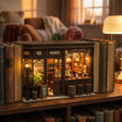 The Hidden Tavern book nook glowing on a bookshelf between books