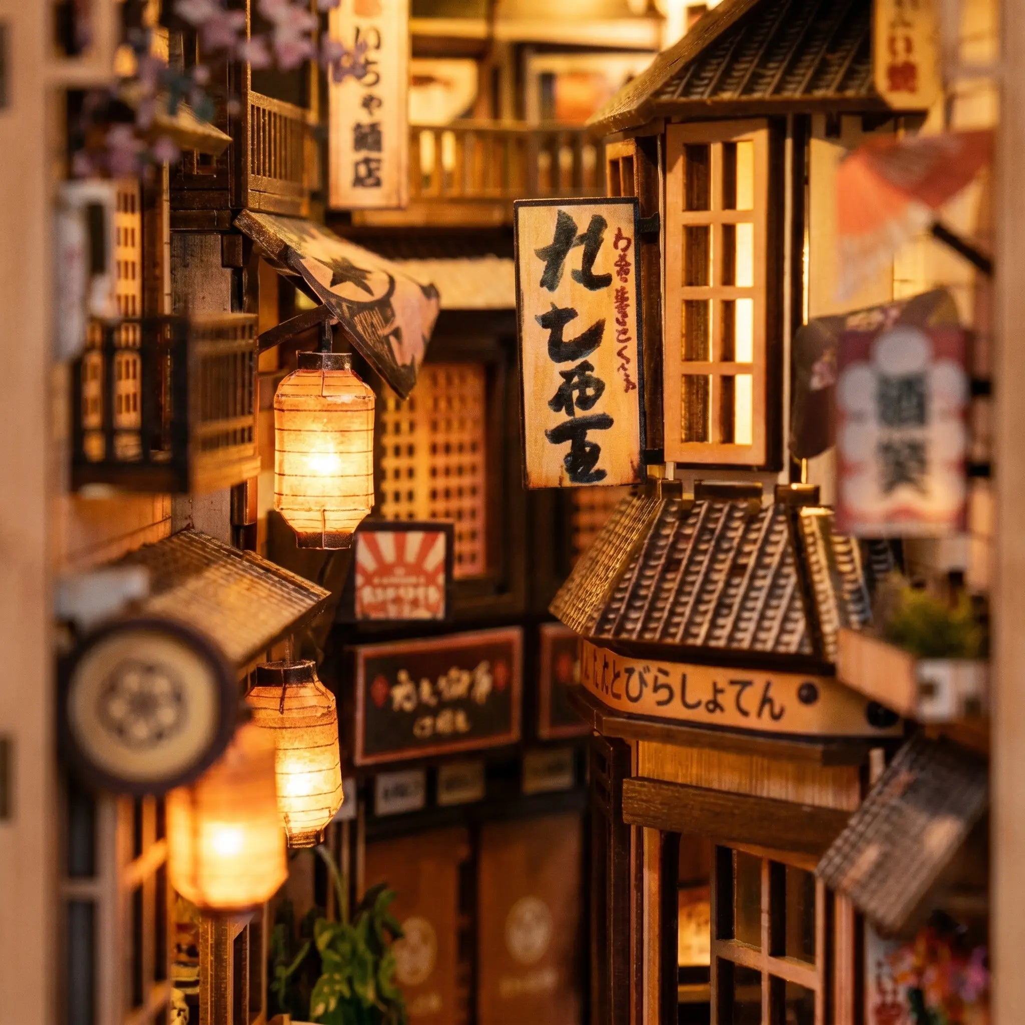 Close-up of the glowing paper lanterns above the alley shopfronts inside The Cat's Alley