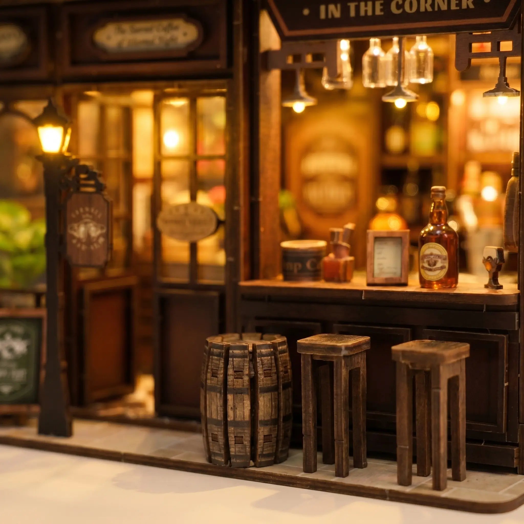 Close-up of the barrels and wooden stools beneath the little street lamp inside The Hidden Tavern