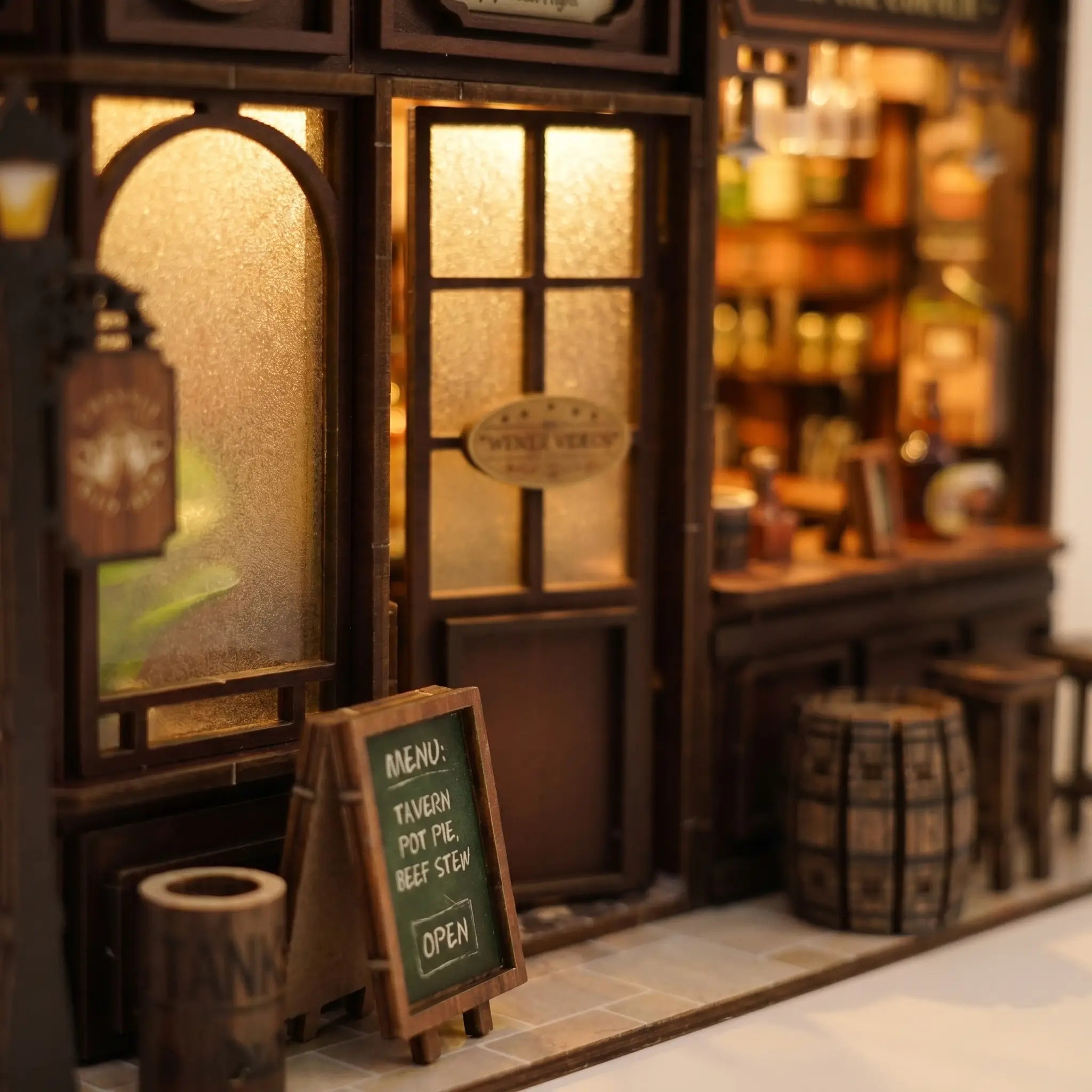 Close-up of the frosted windows and chalkboard menu by the door inside The Hidden Tavern