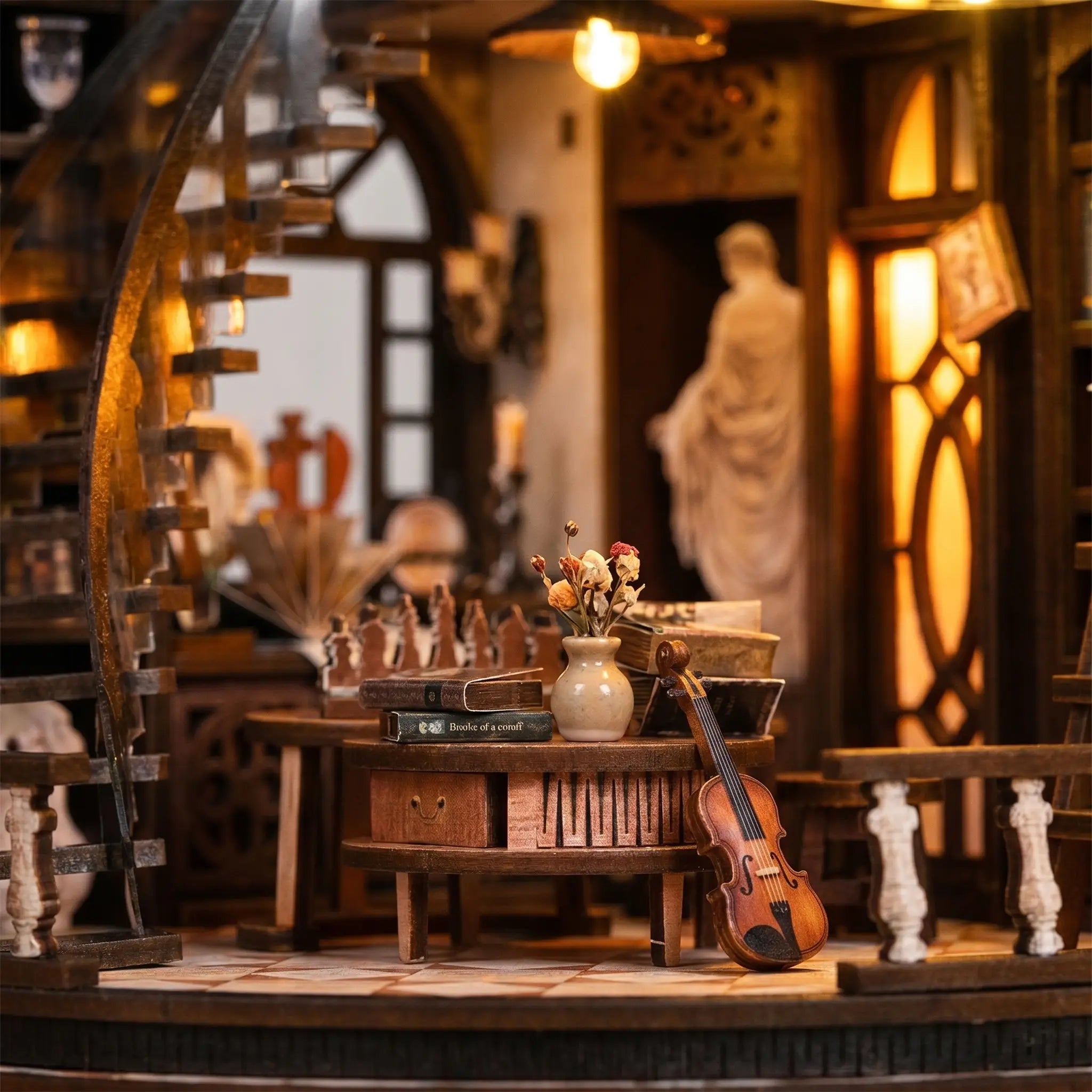 Close-up of the round reading table with books, flowers and a violin beside the arched window inside The Bacchus Bookstore