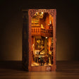 The Story Keeper antique library book nook lit on a dark warm backdrop