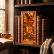 The Story Keeper slotted on a shelf between books at dusk