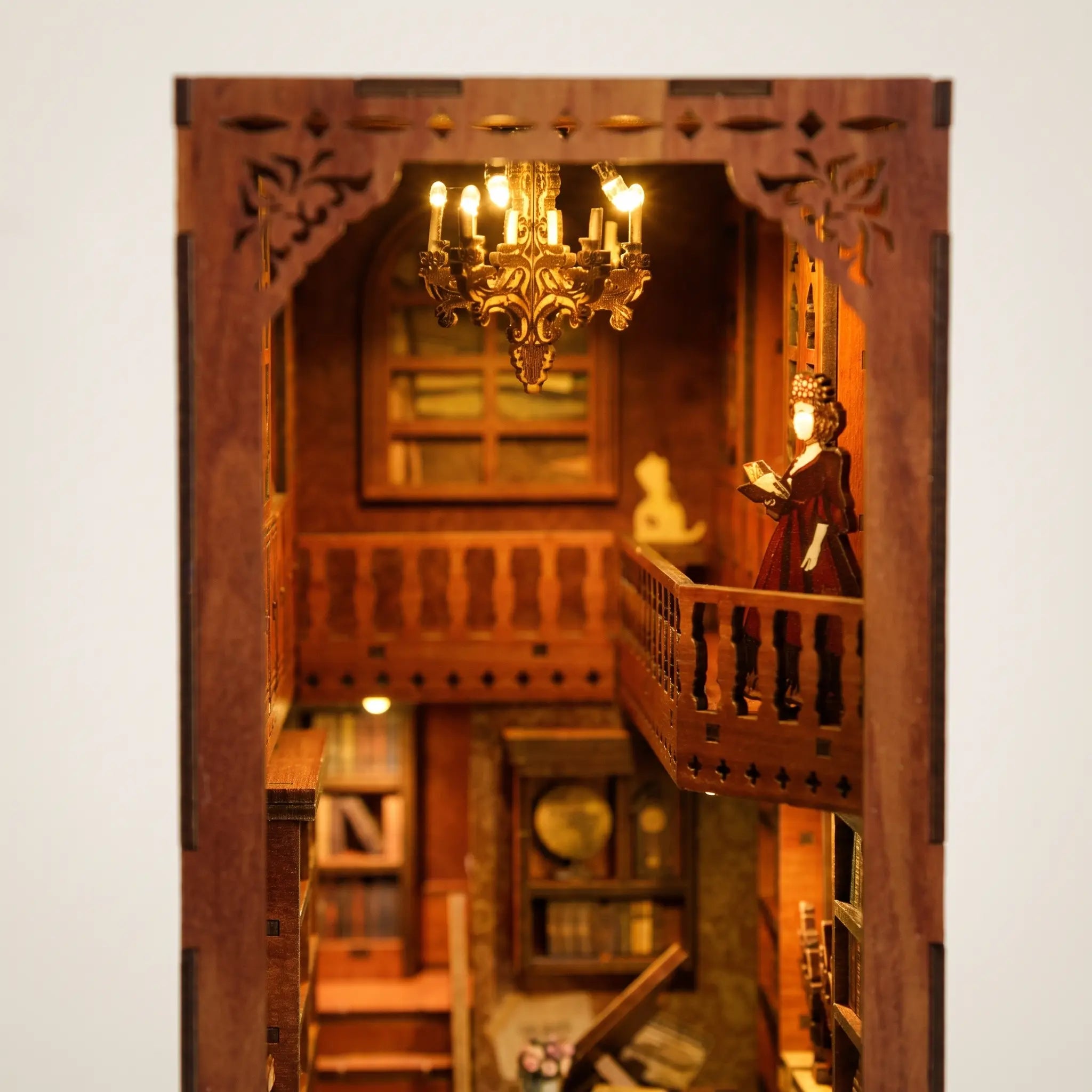 Close up of the glowing chandelier and upper balcony inside The Story Keeper
