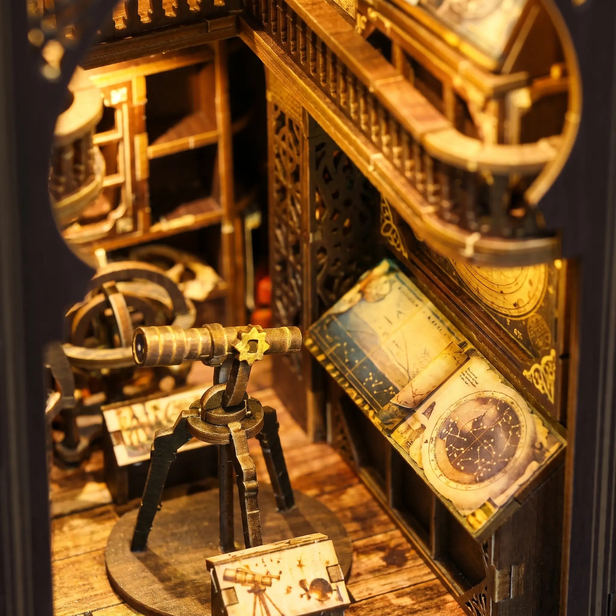 Close-up of the lit interior of The Stargazer, brass telescope and astronomer's desk in warm lamplight