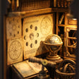 Detail of the moon-phase charts and celestial globe inside The Stargazer book nook