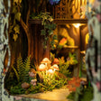 Detail of the glowing mushrooms on the mossy forest floor inside The Fairy Glen book nook