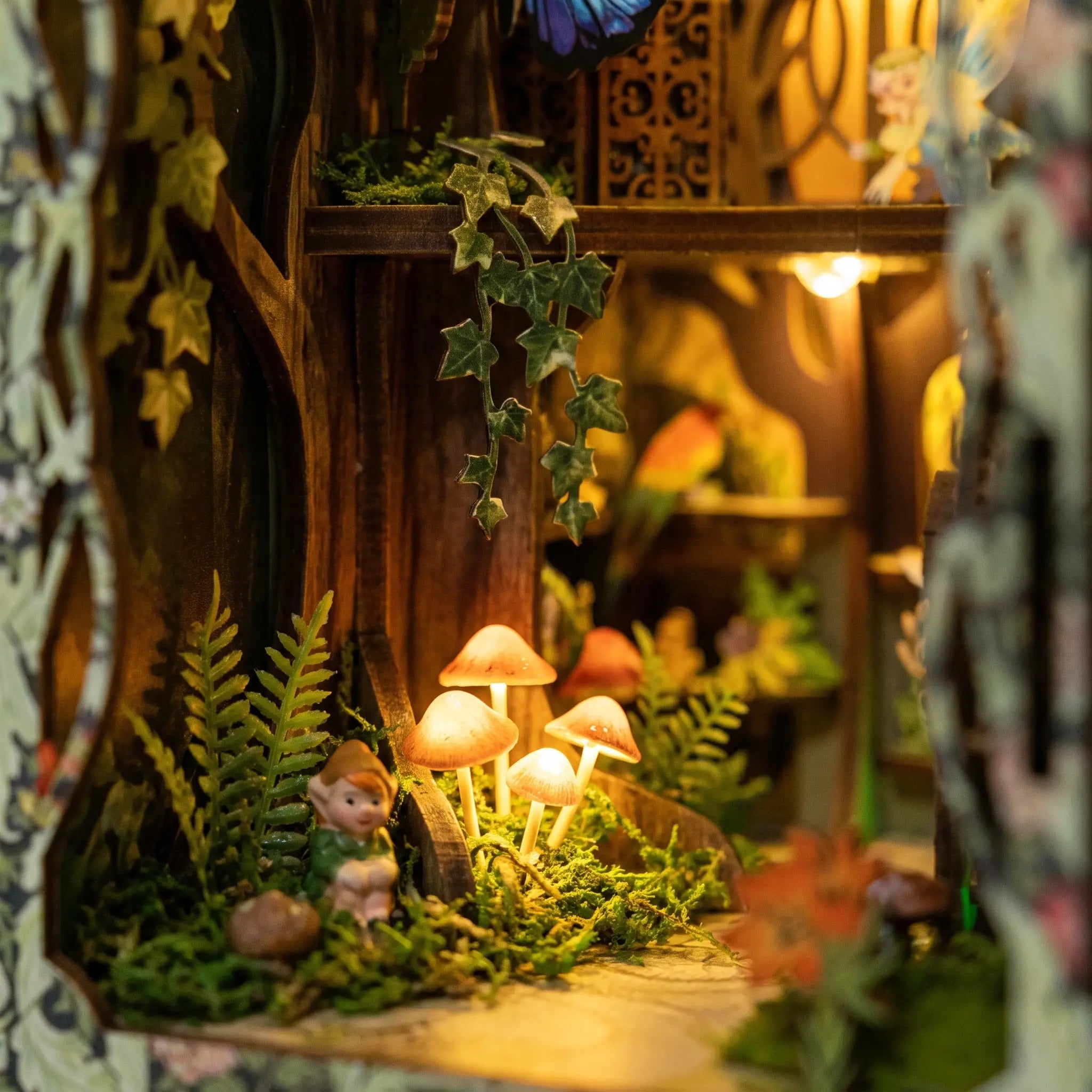 Detail of the glowing mushrooms on the mossy forest floor inside The Fairy Glen book nook