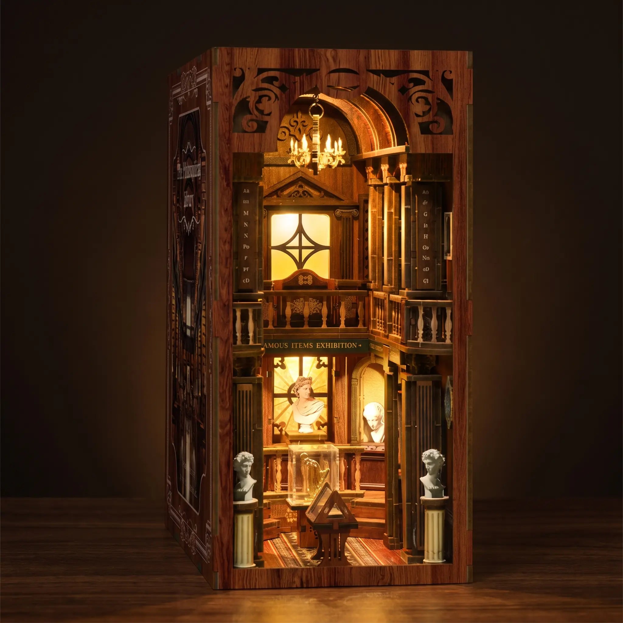 The Grand Exhibition DIY book nook museum hall, dark backdrop hero, warm LED lit