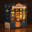 The Corner Bookshop book nook lit and glowing on a dark walnut surface