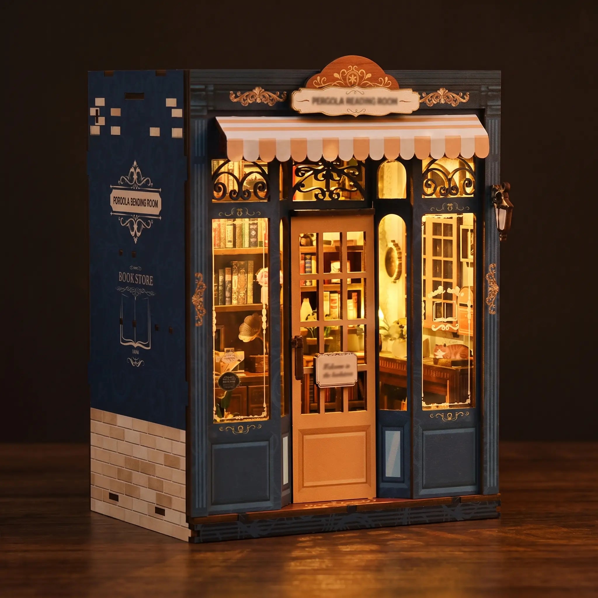 The Corner Bookshop book nook lit and glowing on a dark walnut surface