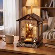The Lantern House miniature Japanese house styled on a desk at dusk
