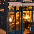 Close-up of the glowing arched display window of The Corner Bookshop