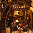 Close-up of the glowing fireplace and leather armchair inside The Cathedral Library