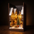 The Winter Lane miniature Christmas village book nook on a dark walnut backdrop