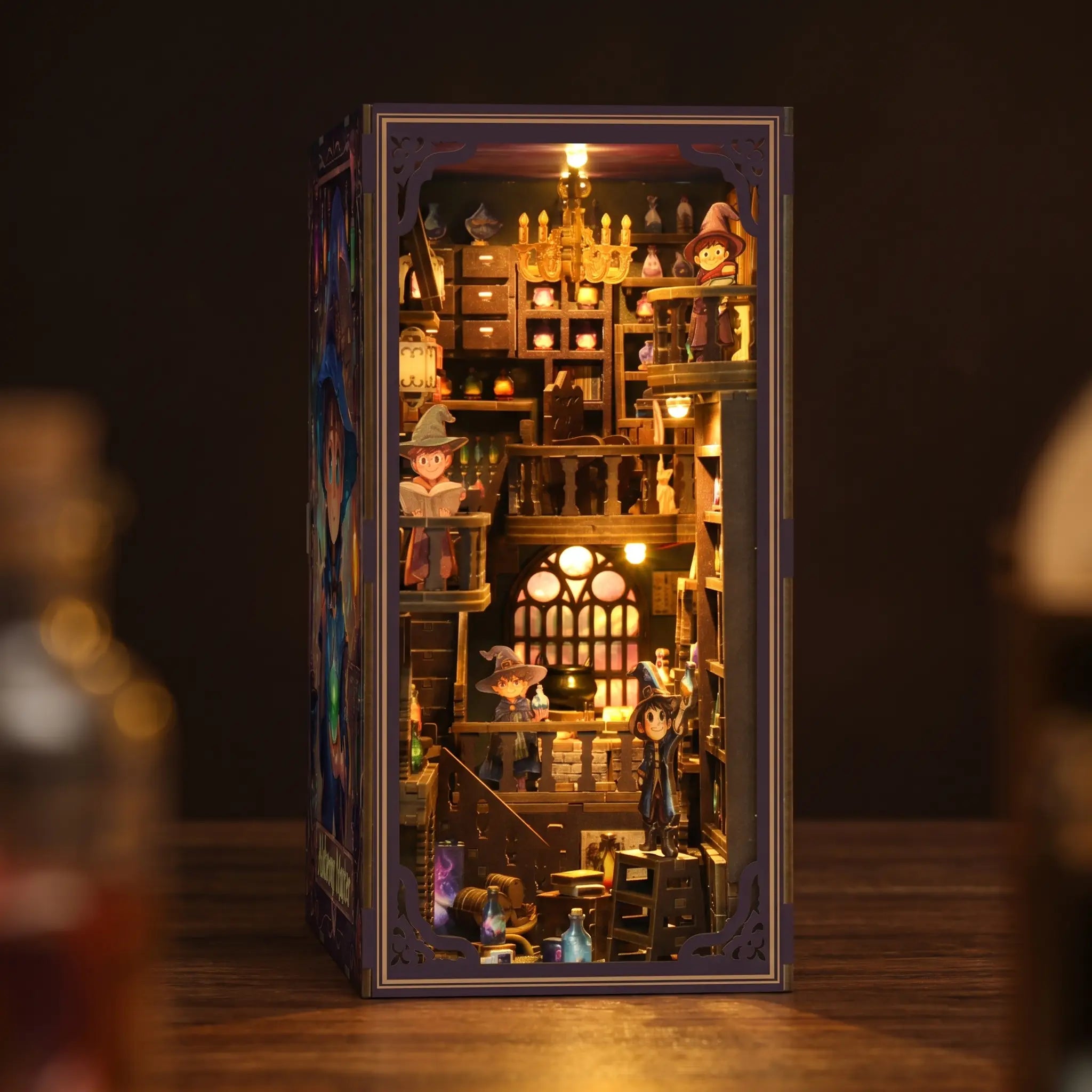 The Alchemy Academy DIY book nook kit, lit interior on a dark backdrop